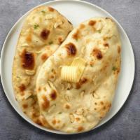 Garlic Geek Naan · Freshly baked bread in a clay oven garnished with garlic and butter