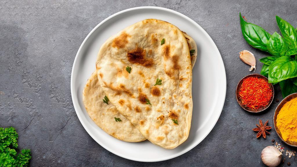 Naan Of The Above · Freshly baked bread in a clay oven garnished with butter