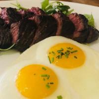 Steak And Eggs · Grilled hangar steak, sunny side up eggs, greens