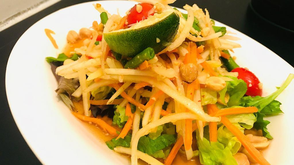 Papaya Salad · Spicy. Green papaya mixed with carrot, cherry tomato, string bean, roasted peanuts in chili lime dressing.