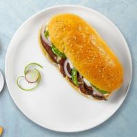 Lily Philly Cheesesteak · Thinly cut steak, melted cheese, onions, and green bell peppers.