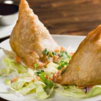 Vegetable Samosa  · Puff pasty stuffed with potatoes and green peas (2pcs).