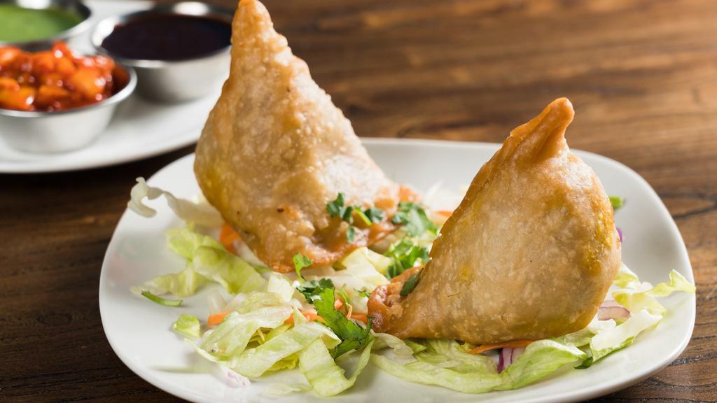 Vegetable Samosa  · Puff pasty stuffed with potatoes and green peas (2pcs).
