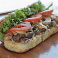 Steak Hoagie Sandwich · Delicious sandwich made with Beef steak, melted cheese, lettuce, tomato, sautéed onions, and...