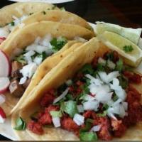 Pollo Tacos (Regular) · Shredded chick with onion and cilantro.