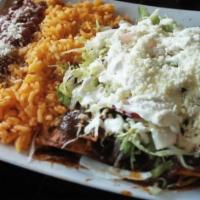 Enchiladas De Mole · Mole with chicken sour cream, lettuce, onions, cheese. Served with rice and beans.