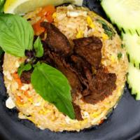 Spicy Basil Fried Rice · Delicious fried rice with eggs, bell peppers, onions, string bean carrots, and basil in a sp...