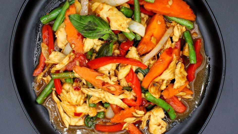 Pad Kra Prow · Classic dish with fresh basil, string beans, onion, bell peppers, carrots, chili and garlic basil sauce.