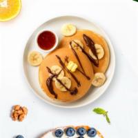 Chocolatey Banana Pancake · Fluffy banana nutella pancakes cooked with care and love served with butter and maple syrup....