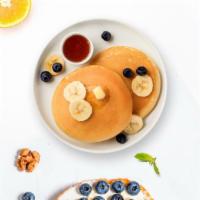 Berry Merry Pancake · Fluffy banana and berries pancakes cooked with care and love served with butter and maple sy...