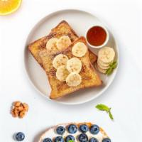 Goin' Bananas French Toast · Fresh bread battered in egg, milk, and cinnamon cooked until spongy and golden brown. Topped...