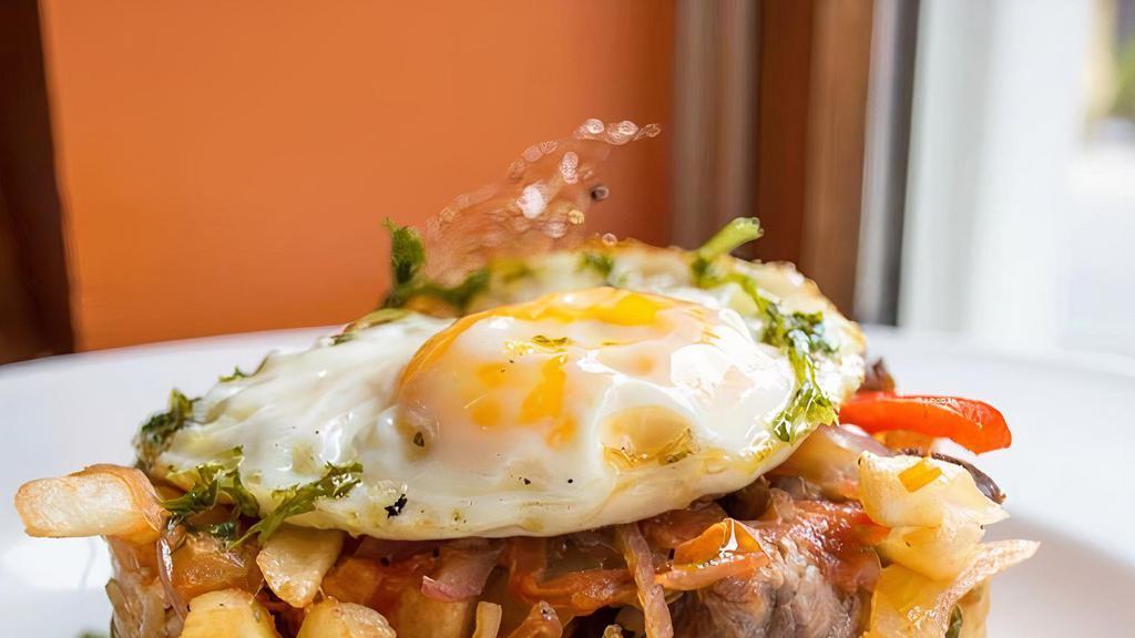 Peru-Lomo Saltado · Gluten free. Sautéed skirt steak, onions, peppers, fries, stir fried rice, chorizo, and fried egg.