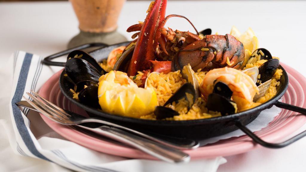 Espana-Palomino Paella · Gluten free. Seafood paella with shrimp, clams, mussels, chorizo, chino latino lobster rice and sofrito sauce.