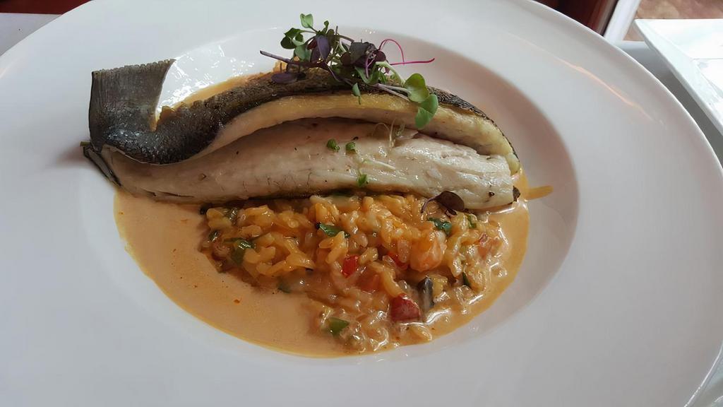 Chile-Robalo Al Sarten · Branzino and manchego cheese, mushrooms, shrimp risotto and fig essence and raspberry sauce.