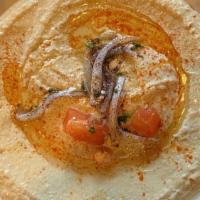 Hummus · Puree of chickpeas, tahini, lemon, and garlic, served with a pita.