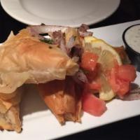 Spanakopita · Filo pastry dough, filled with spinach, feta cheese, and baked until golden brown, served wi...