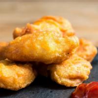 Buffalo Chicken Tenders · Breaded chicken nuggets are crispy outside and tender inside served with buffalo sauce.
