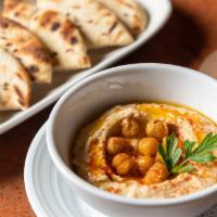 Hummus · Traditional hummus, spices, and pita.