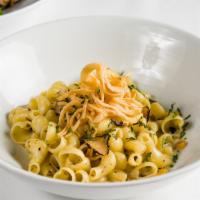 Pasta Tartufata · Hand crafted pasta, black truffles, corn, and crispy onion.