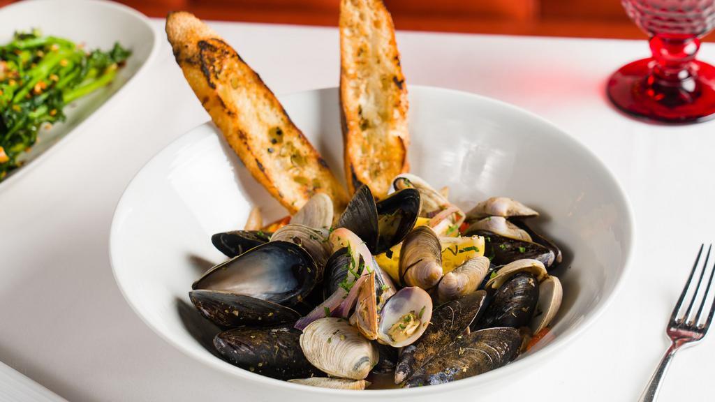 Chardonnay Steamed Mussels And Clams* · P.E.I. mussels, Manila clams, white wine, capers, lemon, and garlic bread.