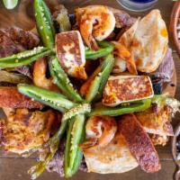 Molcajete · Chicken Fajitas, Steak Fajitas, Chorizo, Shrimp, and Nopales.