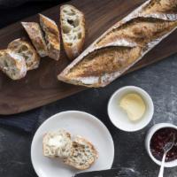 Warm Demi Baguette · Served with seasonal preserves and butter.