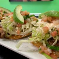 Tostadas De Tinga (3 Pcs) · Crispy tortilla top with re-fried beans, chicken tinga, lettuce, queso fresco, crema Mexican...