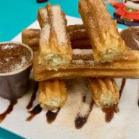 Churros · Served with Nutella and Dulce de Leche.