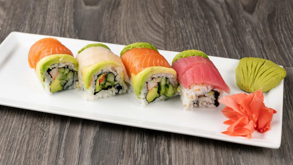 Rainbow Roll · Crab stick, avocado, cucumber topped with fresh salmon & tuna.