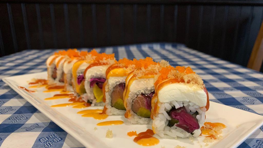 Philadelphia Roll · Smoked salmon, red pickled cucumber, oshinko, topped with masago, cream cheese, spicy mayo & sriracha ketchup.
