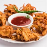 Pakoda · Mildly spiced, chickpea flour vegetable fritters, served with tangy & spicy chutney. Served ...