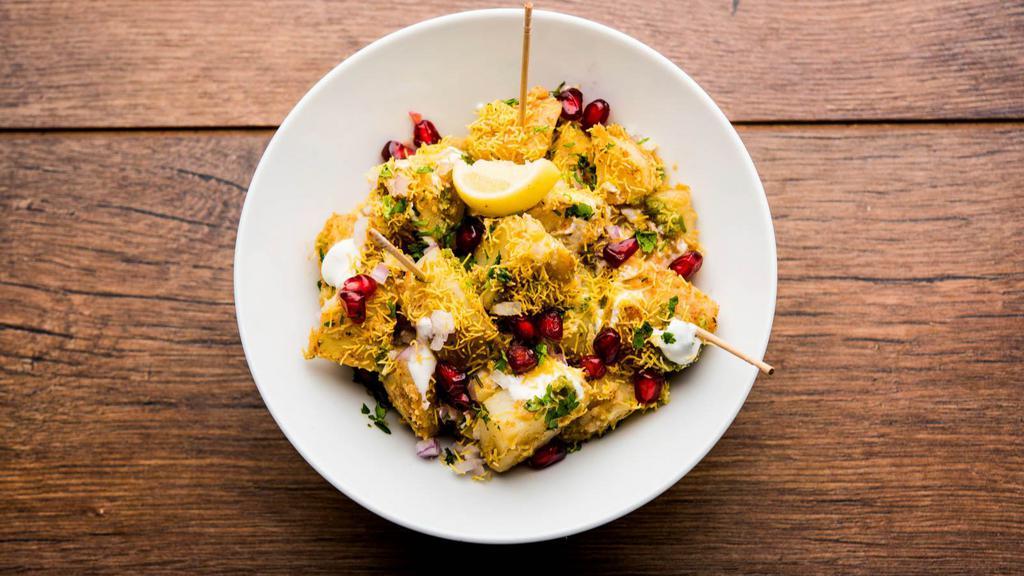 Alu Chaat · Delhi style fried potatoes tossed with onions, chilies, spices & cilantro.