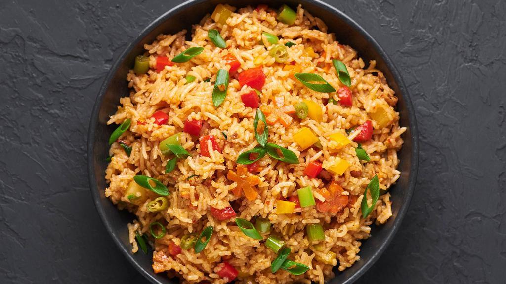 Vegetable Fried Rice · Basmati rice cooked with spring onions, cabbage, carrots, green peas & spices.