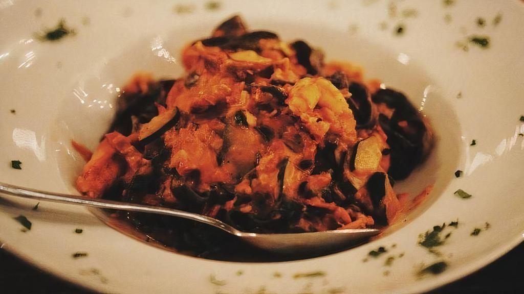 Black Fettucine With Lobster · Squid ink fettucine with lobster, zucchini and sundried tomatoes, in a vodka sauce.