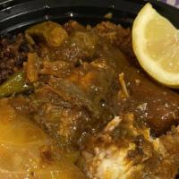 Suppa Kandja (Okra Sauce) · Mixed Lamb and fish in a golden palm oil sauce flavored with chopped okra, served with white...