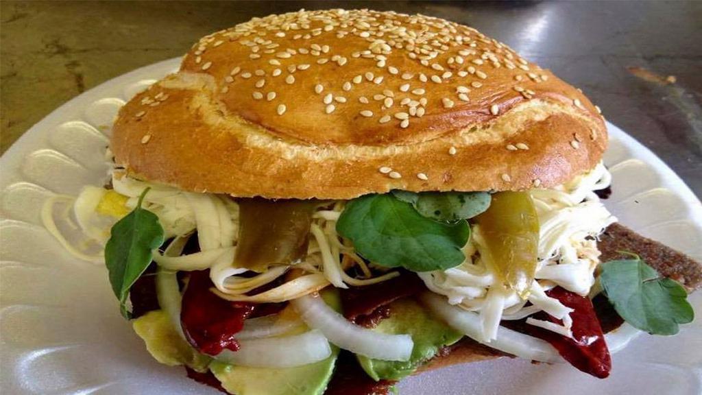 Ham Cemita / Cemita De Jamon · MADE WITH PURE CEMITA BREAD WE ADD MAYONNAISE, AVOCADO, ONION MOZARELLA CHEESE, OAXACA CHEESE, JALAPENO, CHIPOTLE SAUCE AND MEAT OF YOUR CHOICE.

HECHA CON PURO PAN DE CEMITA AGREGAMOS MAYONESA, AGUACATE, CEBOLLA QUESO MOZARELLA, QUESO OAXACA, JALAPENO, SALSA CHIPOTLE Y LA CARNE A SU ELECCION.