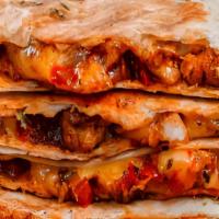 Quesadillas · Flour tortilla, grilled with mozzarella and Cheddar cheese, peppers, onions, and tomatoes. A...