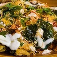 Palak Chaat · Fried spinach, potatoes with fried lentil balls and chutneys.