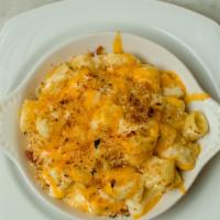 Mac & Cheese · Little rigatoni in a three cheese bechamel baked with garlic and prosciutto bread crumbs.