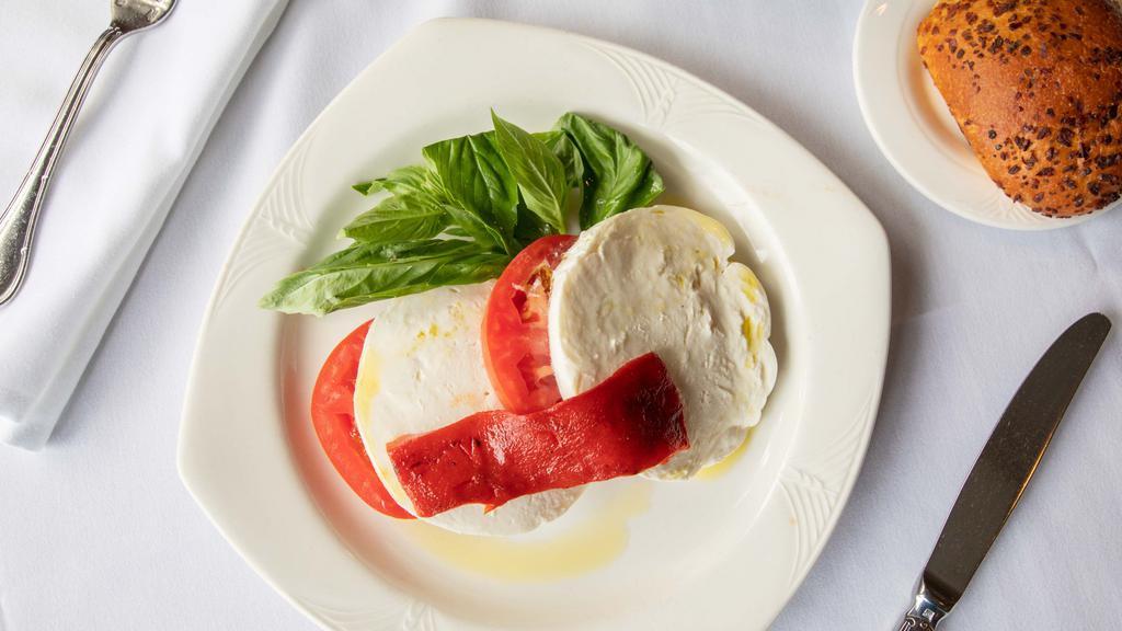 Caprese Salad · House made fresh mozzarella, beefsteak tomato, fresh basil drizzled with extra virgin olive oil.