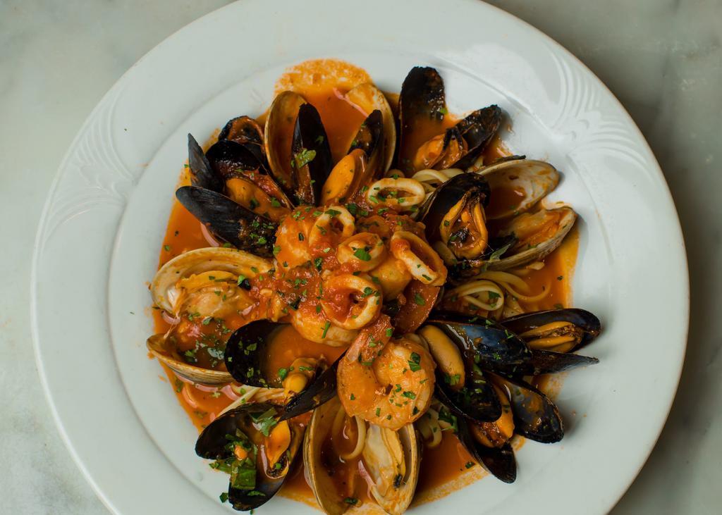 Linguini Alla Pescatori · Jumbo shrimp, calamari, black mussels, little neck clams, sea scallops, tomato basil sauce, topped with toasted garlic and herb bread crumbs.