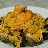 Paella Valenciana · Jumbo shrimp, calamari, black mussels, clams, sea scallops, chorizo sausage, chicken, pepper...