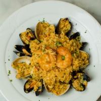 Seafood Paella · Clams, mussels, sea scallops, jumbo shrimp and calamari, tomato saffron rice with peas and r...