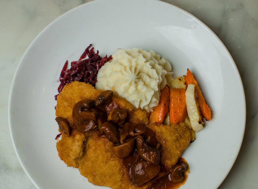 Pork Schnitzel · Breaded pork cutlet, wild mushroom Demi, sweet potato mashed, roasted root vegetable and braised red cabbage.