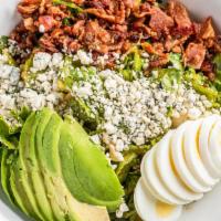 California Cobb Salad · Chopped romaine tossed with French dressing and topped with chopped smoked applewood bacon, ...