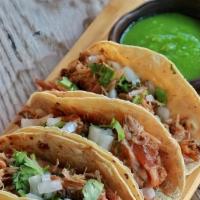 Carnitas Tacos · Salsa cruda, pork rinds, onions, cilantro