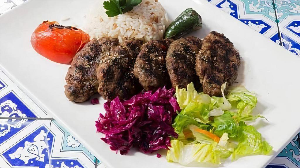 Turkish Meatballs Kofte · Dairy-free.

Char grilled ground lamb and beef seasoned with Turkish spices and served with rice, lettuce, and red cabbage.