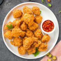 Chicken Popcorn · Bite-size pieces of chicken breaded and fried until golden brown.