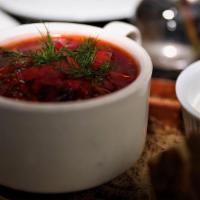 Borscht Soup · Flavorful beet, cabbage, carrot, and fresh herb soup. Served with sour cream and Georgian br...