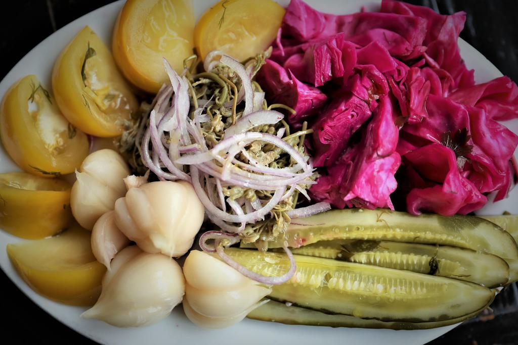 Pickle Assortment · Cucumber, tomatoes, garlic, jonjoli (capers), red cabbage. Gluten free, Vegan, Keto Friendly.